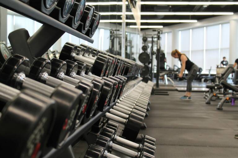 A woman training with weights in a gym