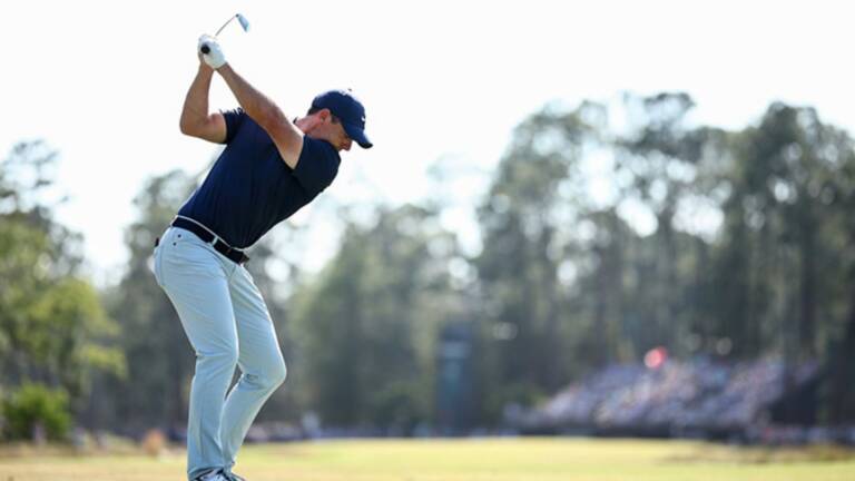 A golfer at the top of the backswing