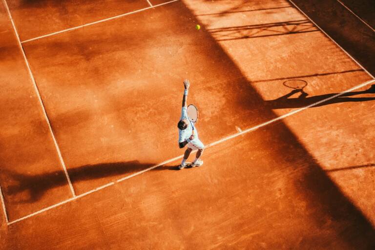 A tennis player hitting a forehand